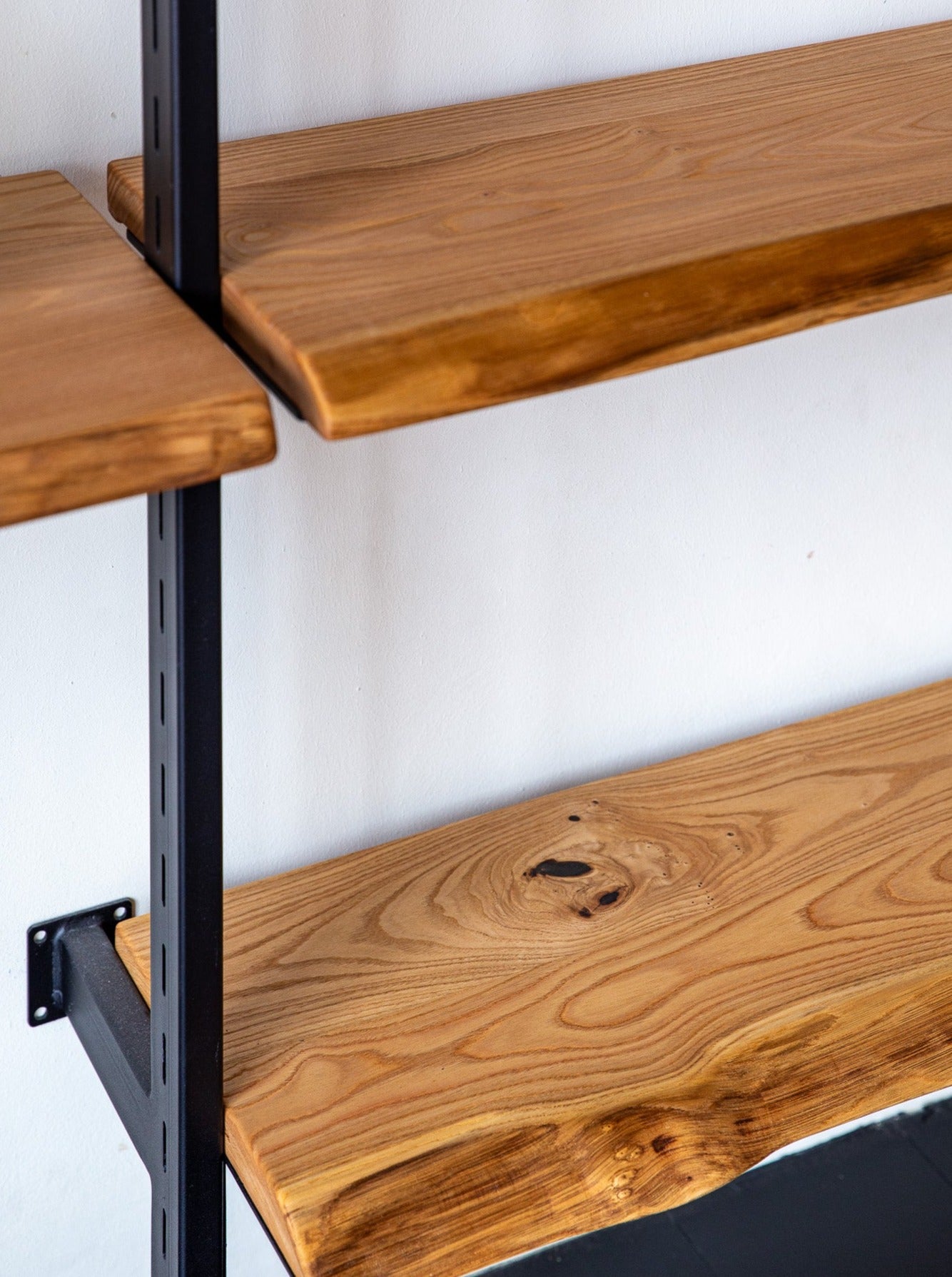 Close up of Chestnut Wood Shelves on the Adjustable Atlas Shelf System by The Table Guy